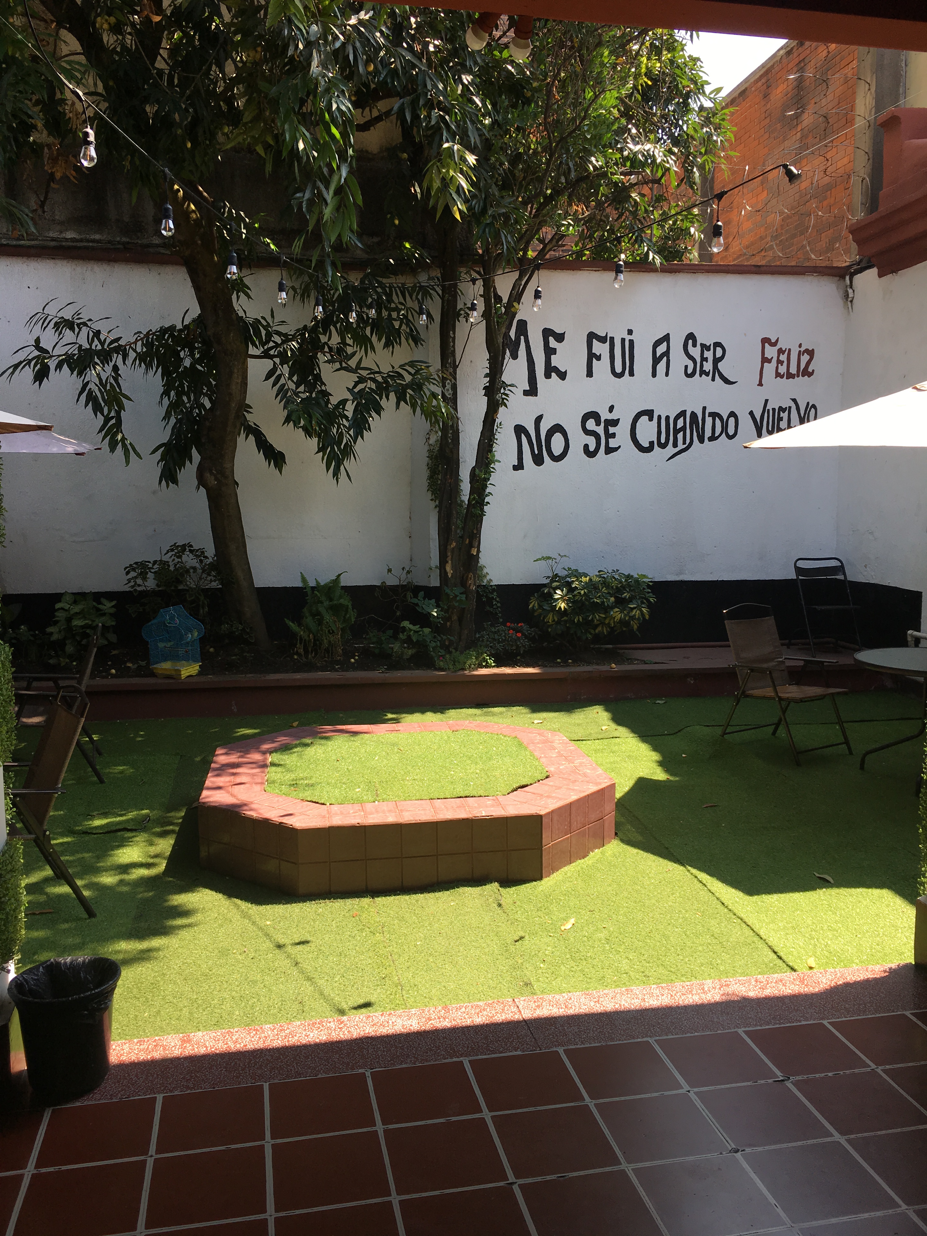 The lobby of the hostel has no roof and displays inspirational writing.